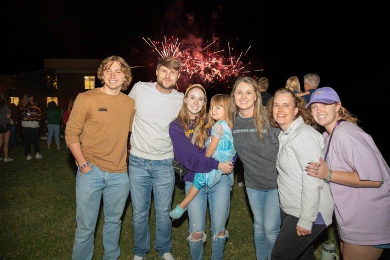 Family Group Photo at Homecoming with Fireworks in the background